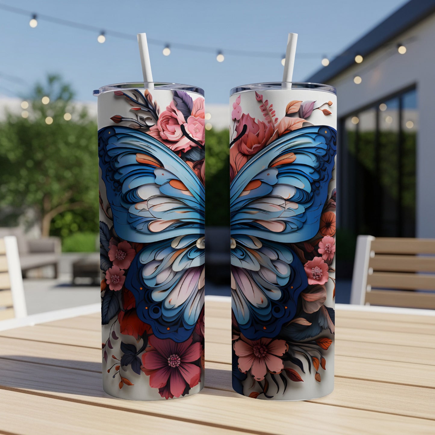 Two tumblers featuring a blue butterfly and floral design on a wooden table.