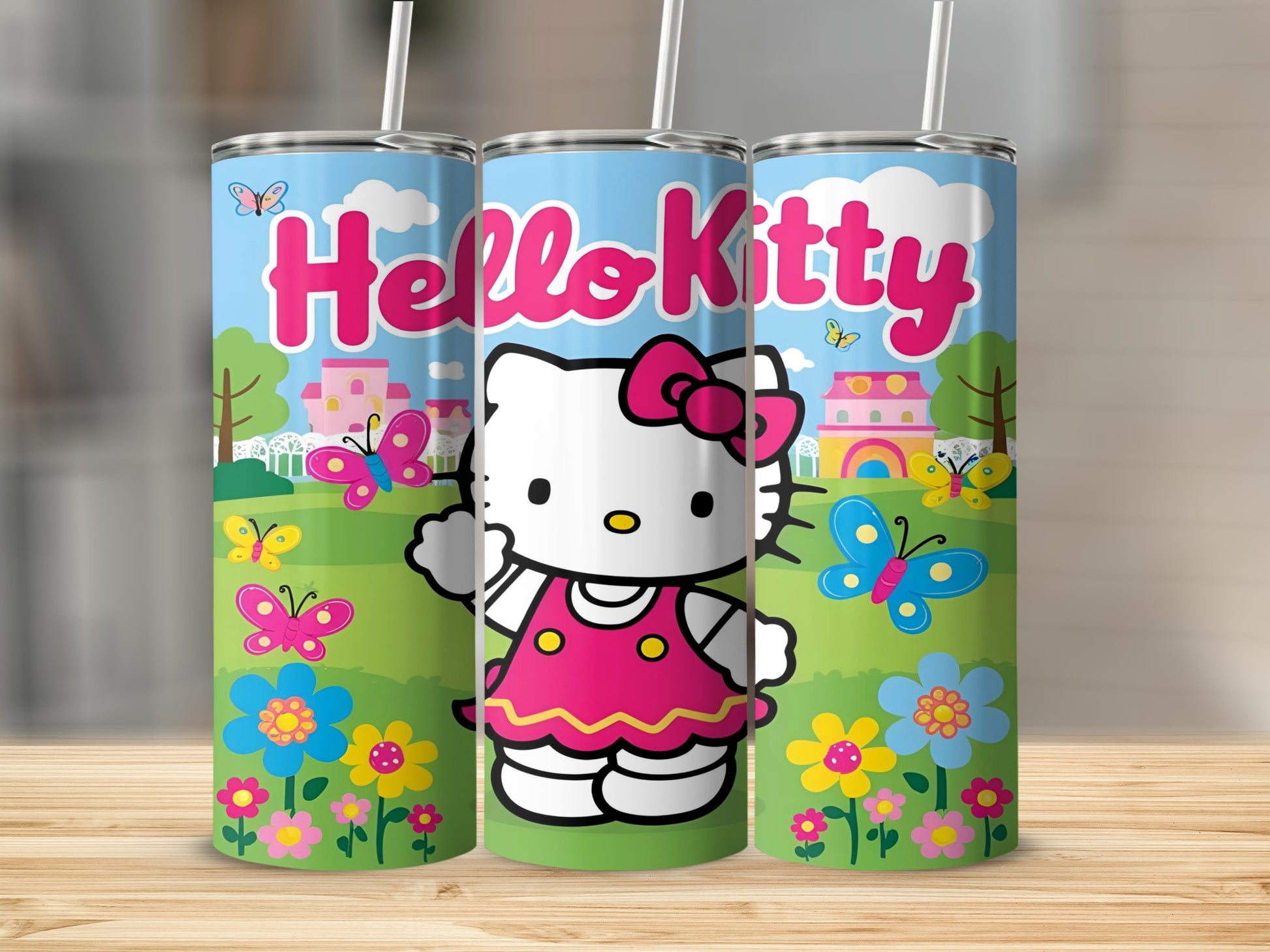 Hello Kitty tumbler with butterflies and flowers in a cartoon landscape.