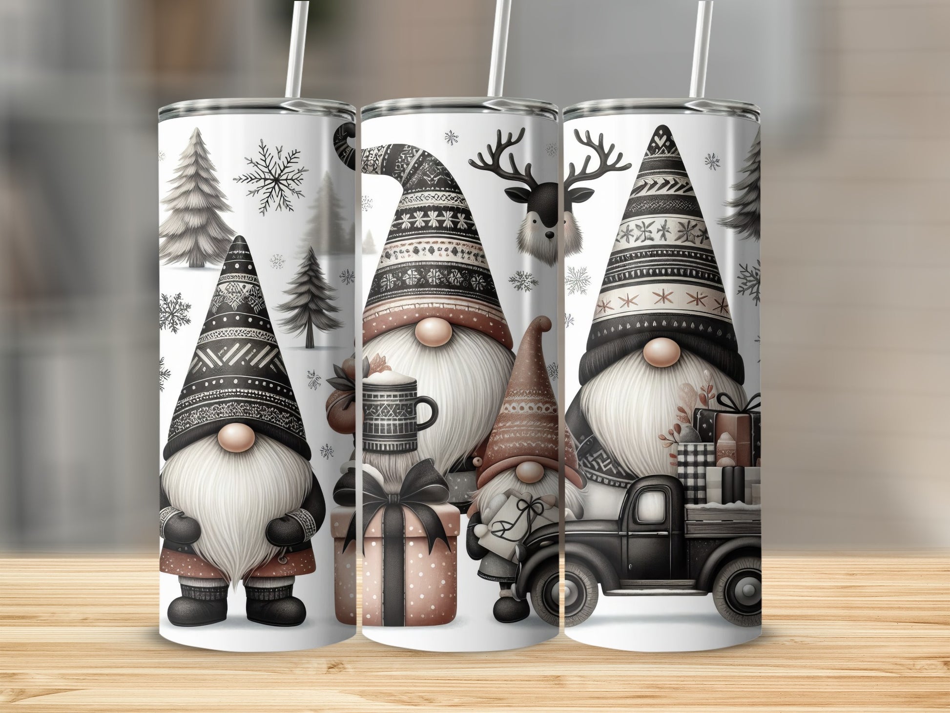 Three tumblers with gnome, deer, and Christmas tree designs.