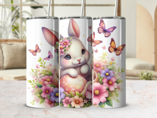 Easter bunny with colorful butterflies and flowers on a tumbler.