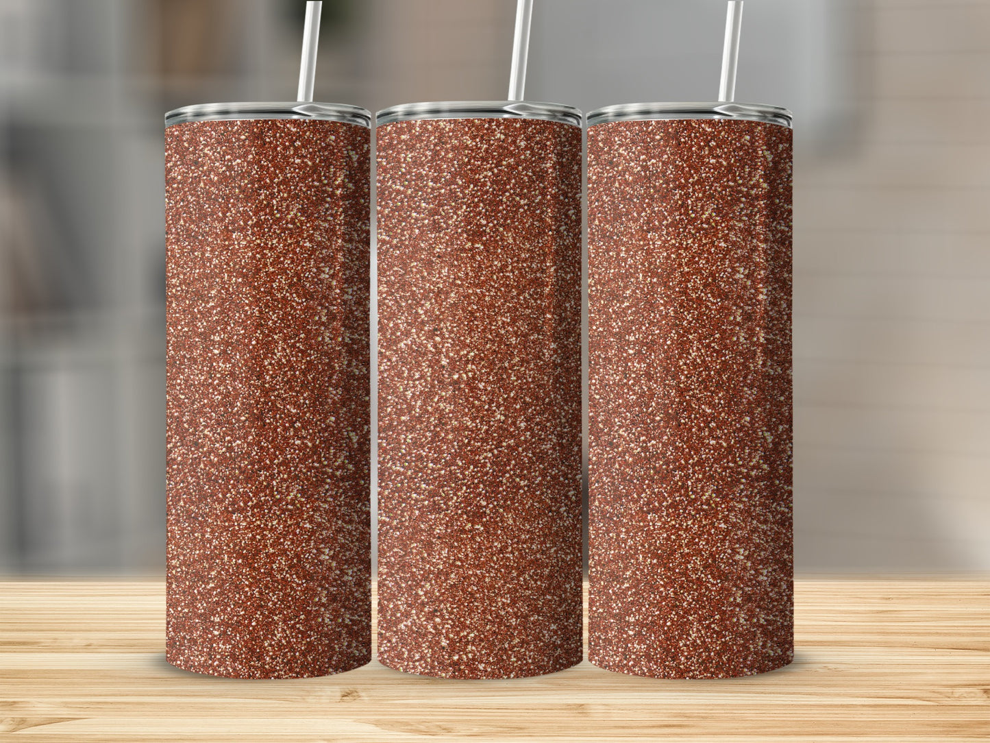 Three tumblers with a speckled brown glitter design and straws.