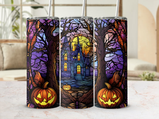 Halloween tumbler with spooky castle, pumpkins, and trees.