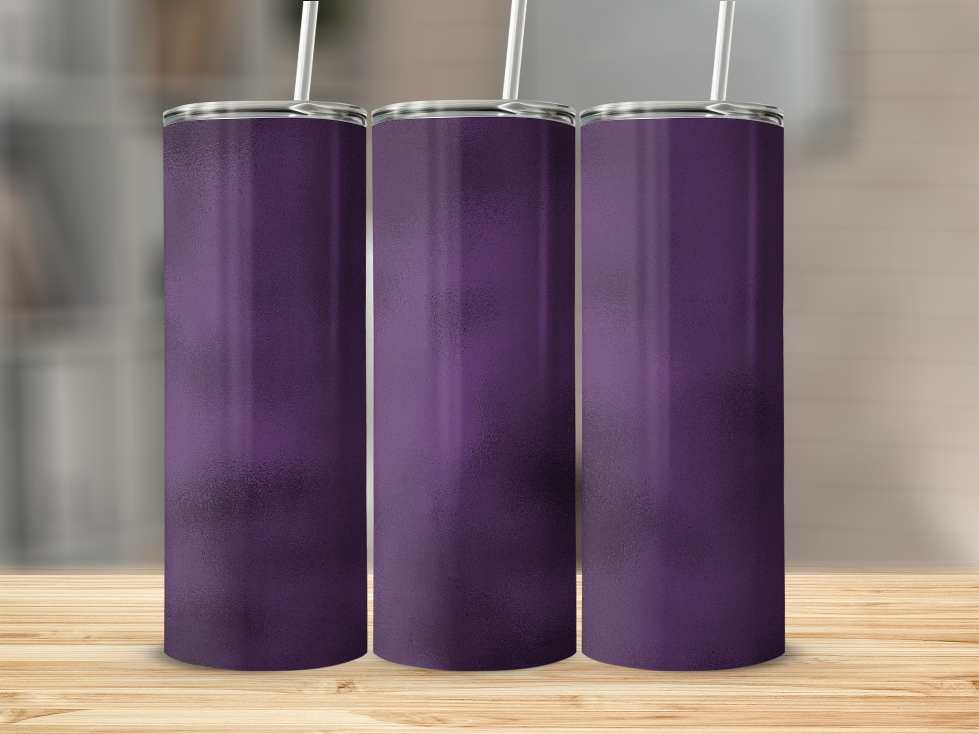 Three tall purple tumblers with straws stand on a wooden surface.