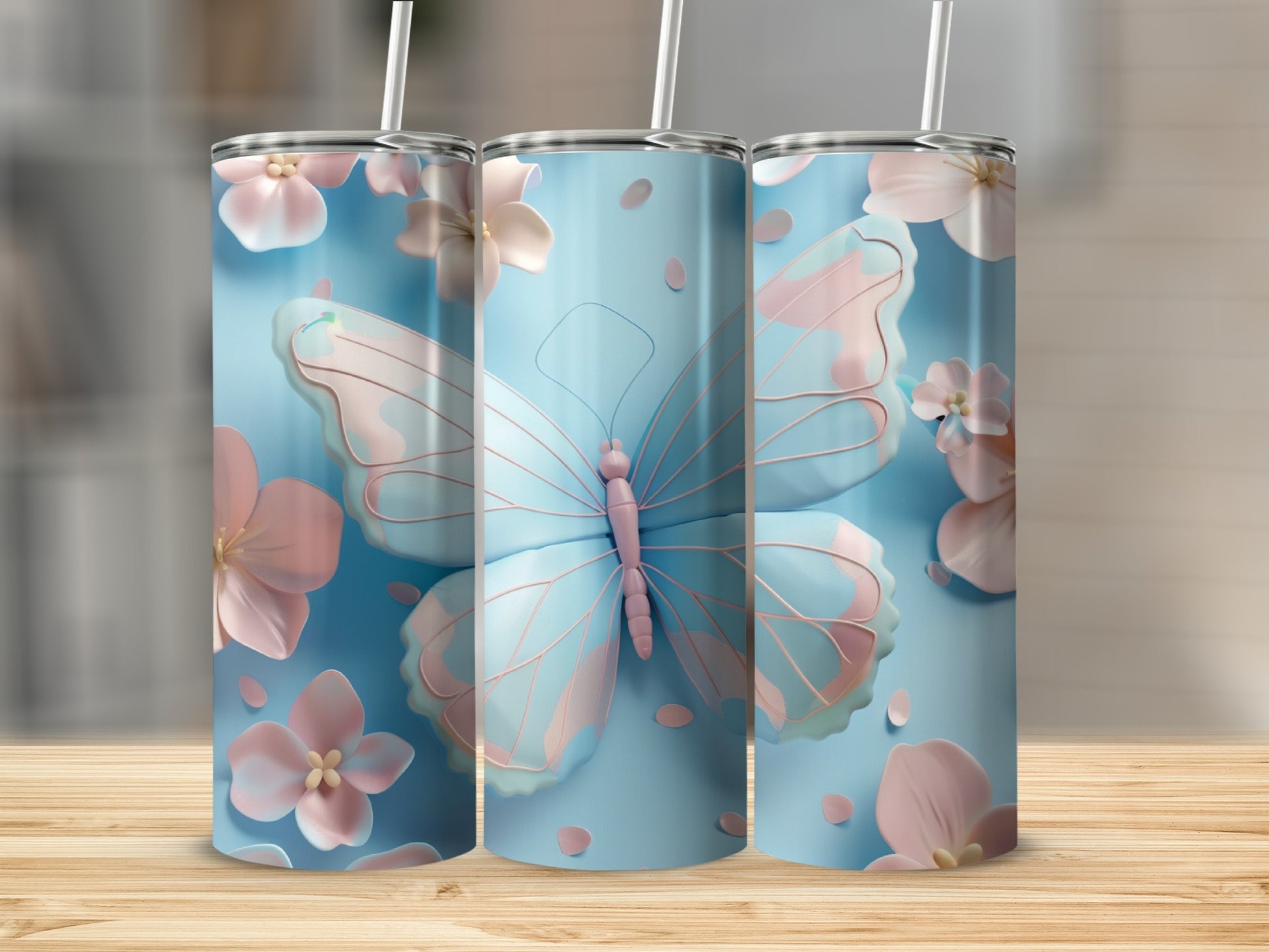 Three light blue tumblers with pink butterflies and flowers.
