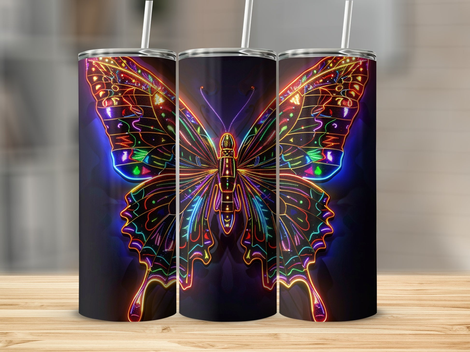 Three tumblers with colorful, glowing neon butterfly designs on a wooden surface.