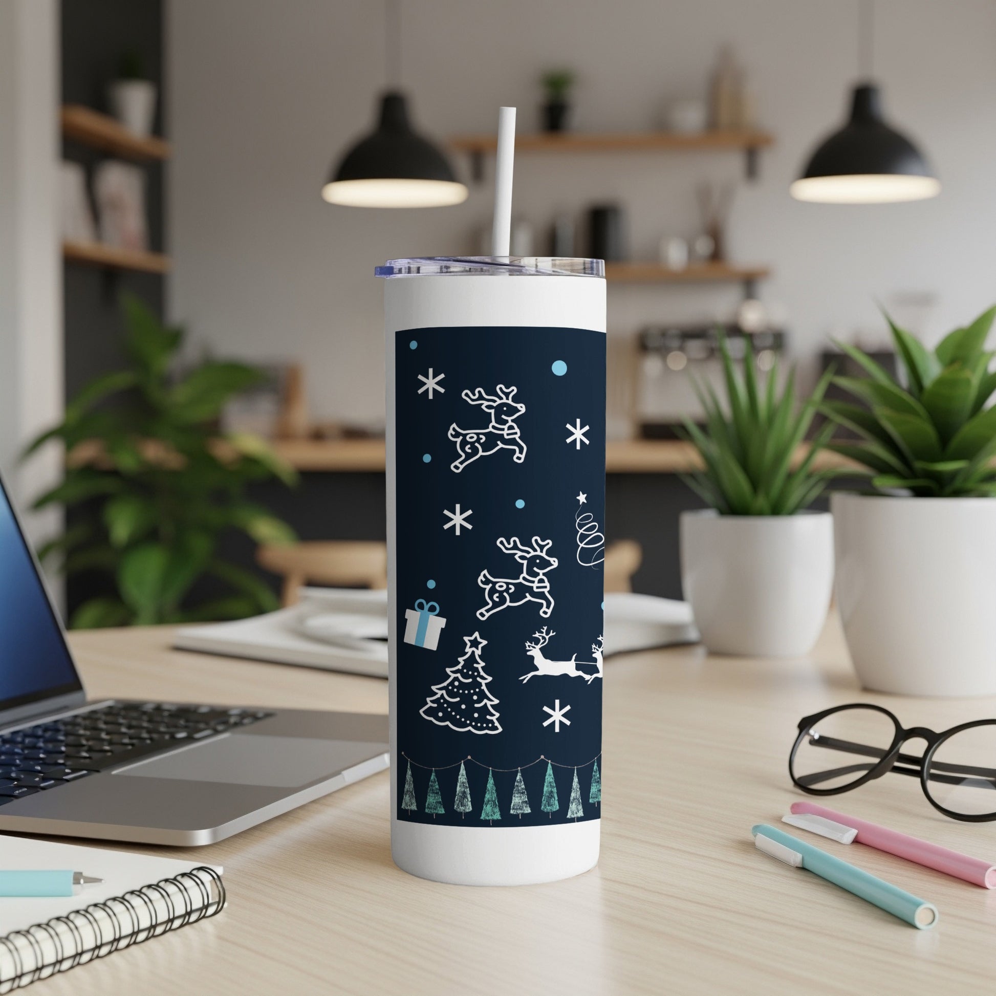White Christmas pattern on a dark blue tumbler with a white straw.