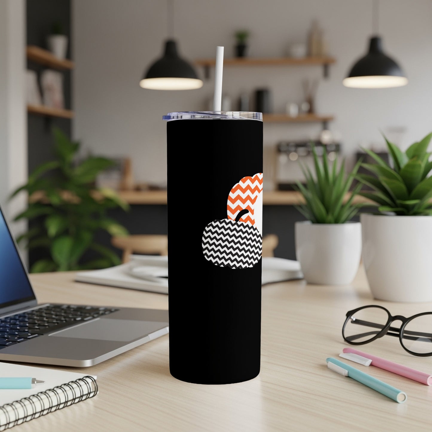Black tumbler with orange and black zigzag and chevron pumpkin design.