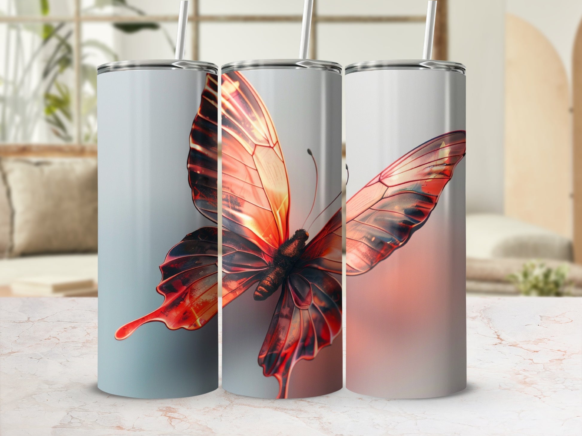 Three tumblers featuring a vibrant orange and red butterfly design.