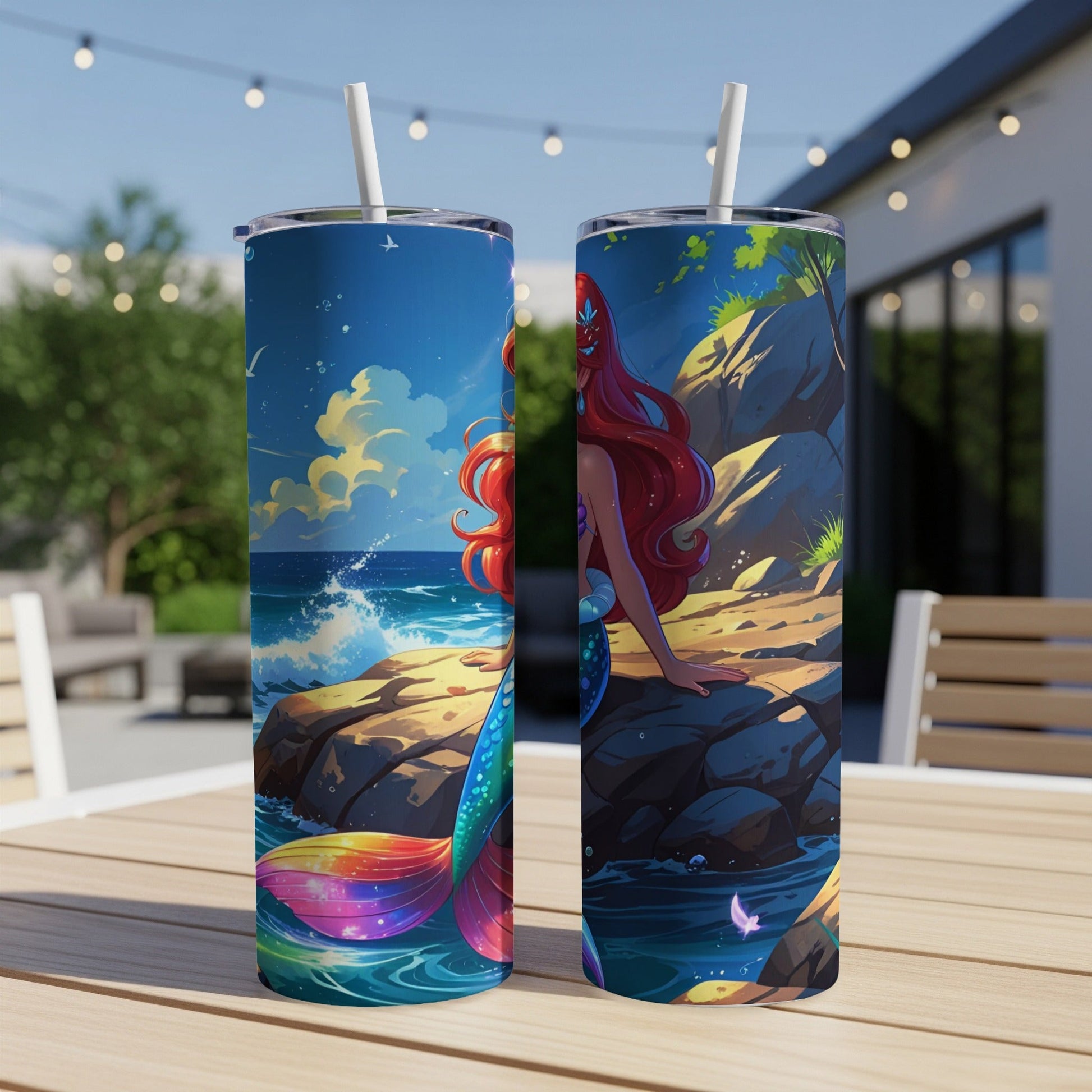 Two tumblers with a mermaid, waves, and rocky shore scene.